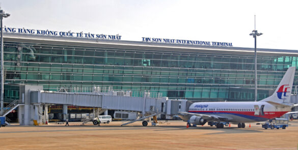 Tan Son Nhat International Airport terminal in Ho Chi Minh City with airplanes parked on the tarmac.- travel between Hanoi and Ho Chi Minh City